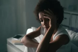 a woman unable to sleep due to restless legs syndrome