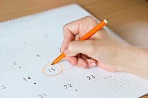 a woman who has irregular periods, marking the date in her calendar