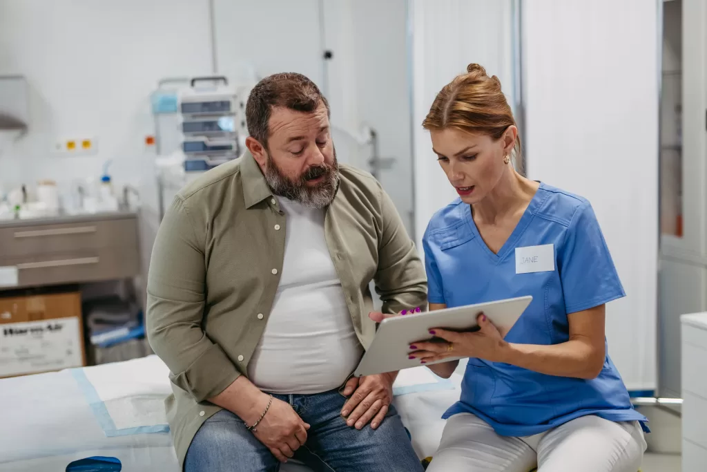 Female doctor consulting with overweight patient, discussing liver test results