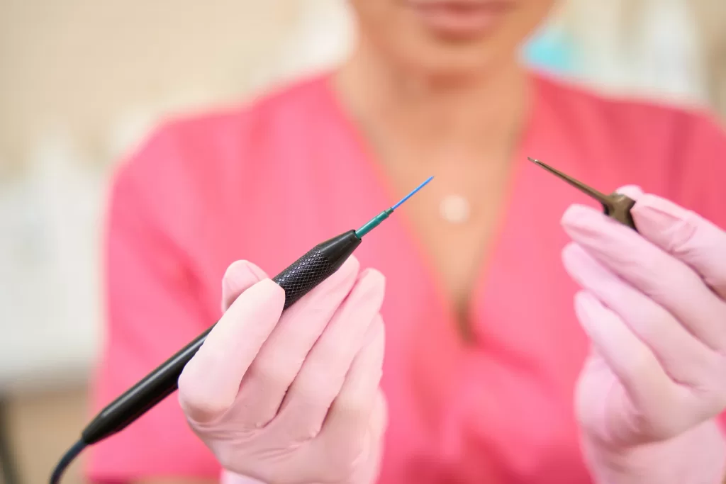 Female doctor holds scalpel in her hands to treat scrotal angiokeratoma Female doctor holds scalpel in her hands to treat scrotal angiokeratoma